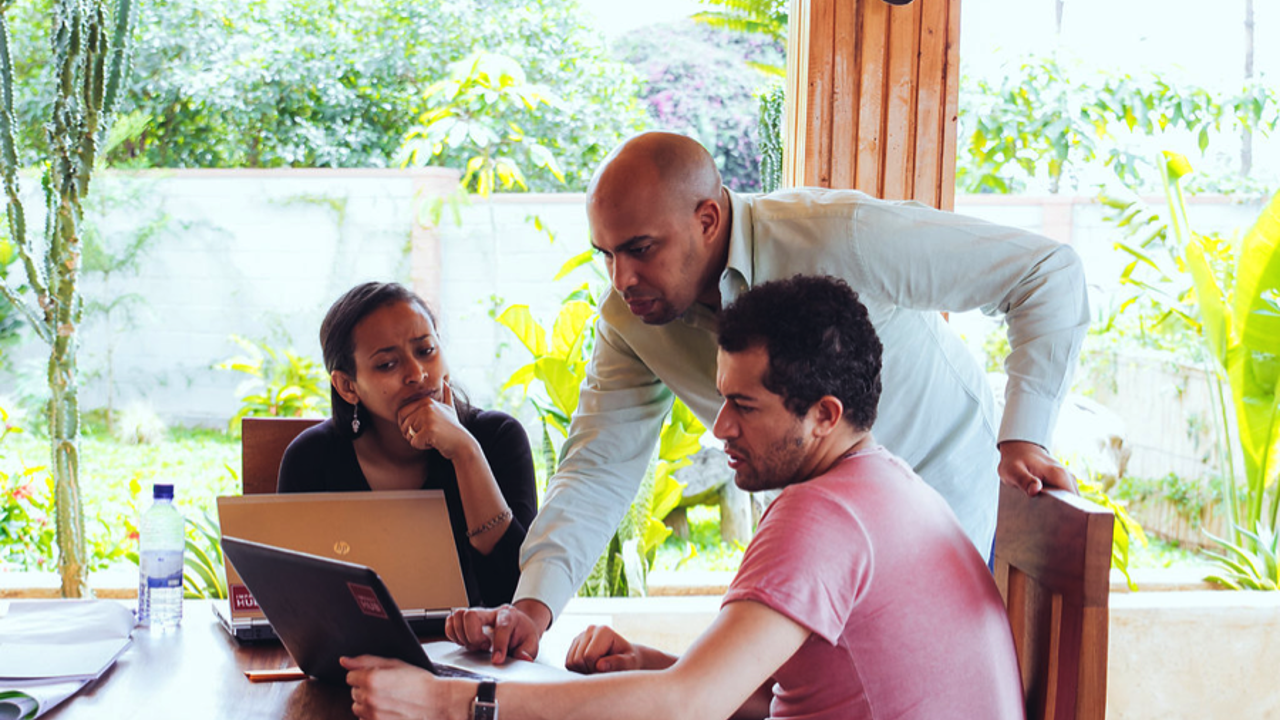 Impact Hub People Looking At Laptops