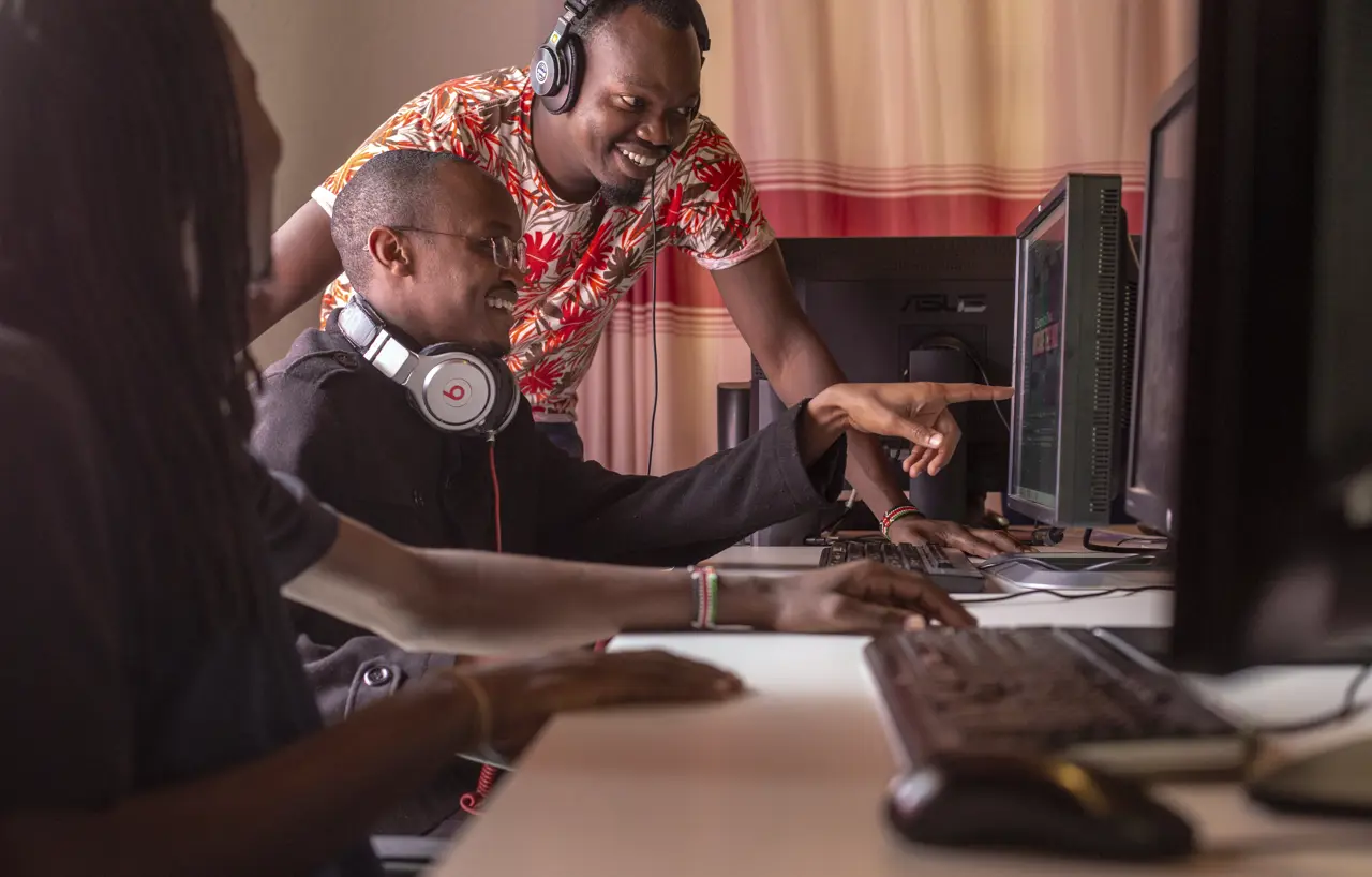 Men pointing at screen