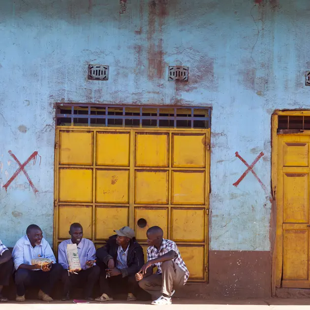 2133 Five Men Sitting Outside Building Sorghum Pioneer Root Capital Stuart Freedman