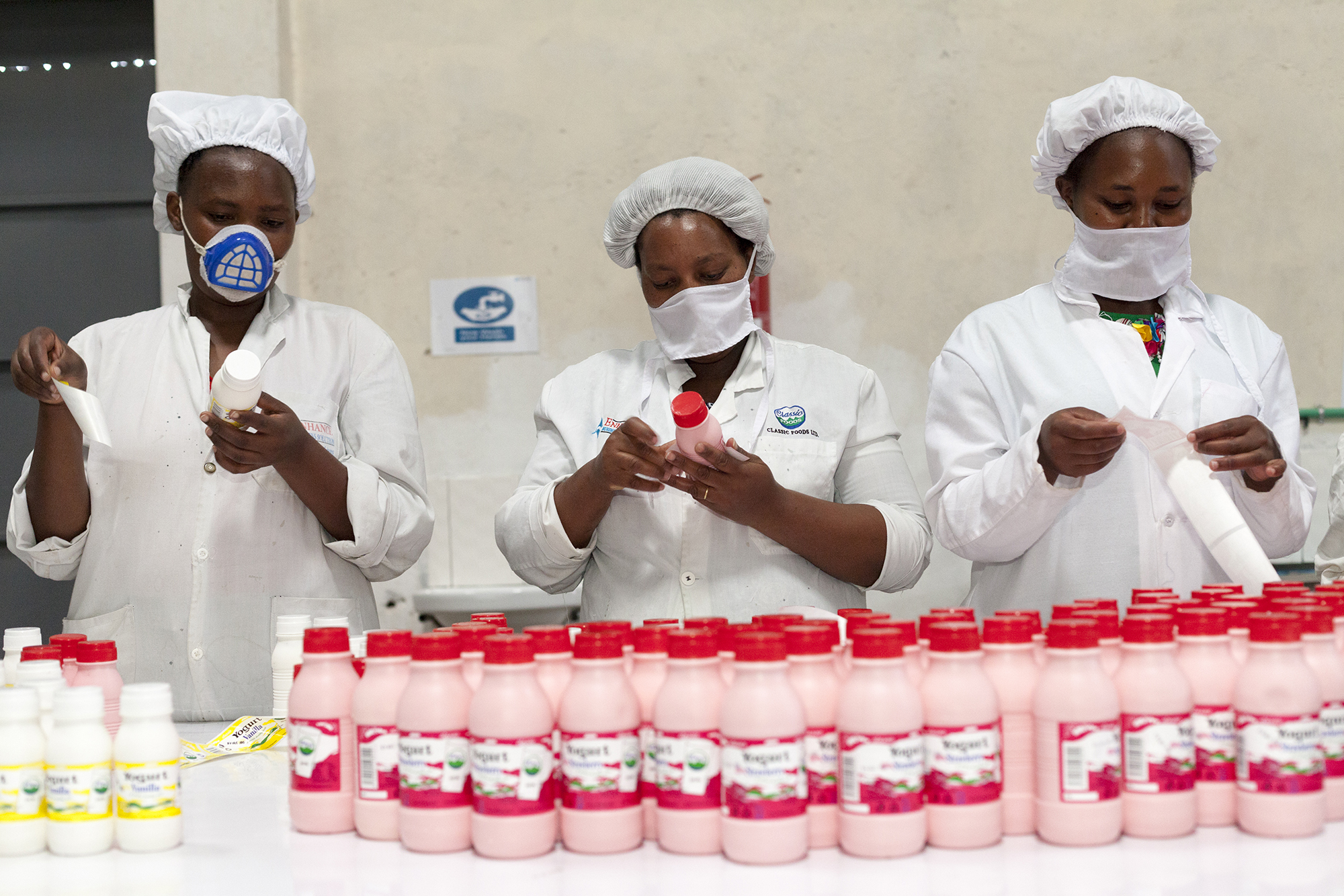218 Woman Pasting Stickers On Products Growth Africa Classic Foods Copyright Stuart Freedman