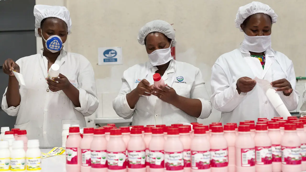 218 Woman Pasting Stickers On Products Growth Africa Classic Foods Copyright Stuart Freedman
