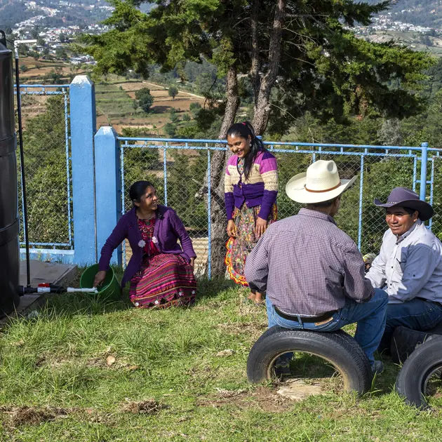 2136 4 People Collecting Clean Water From Tank Innoverde Alterna Stuart Freedman