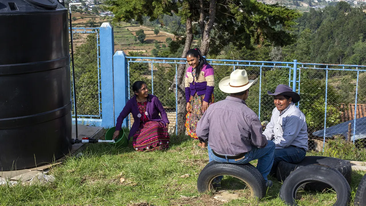 2136 4 People Collecting Clean Water From Tank Innoverde Alterna Stuart Freedman