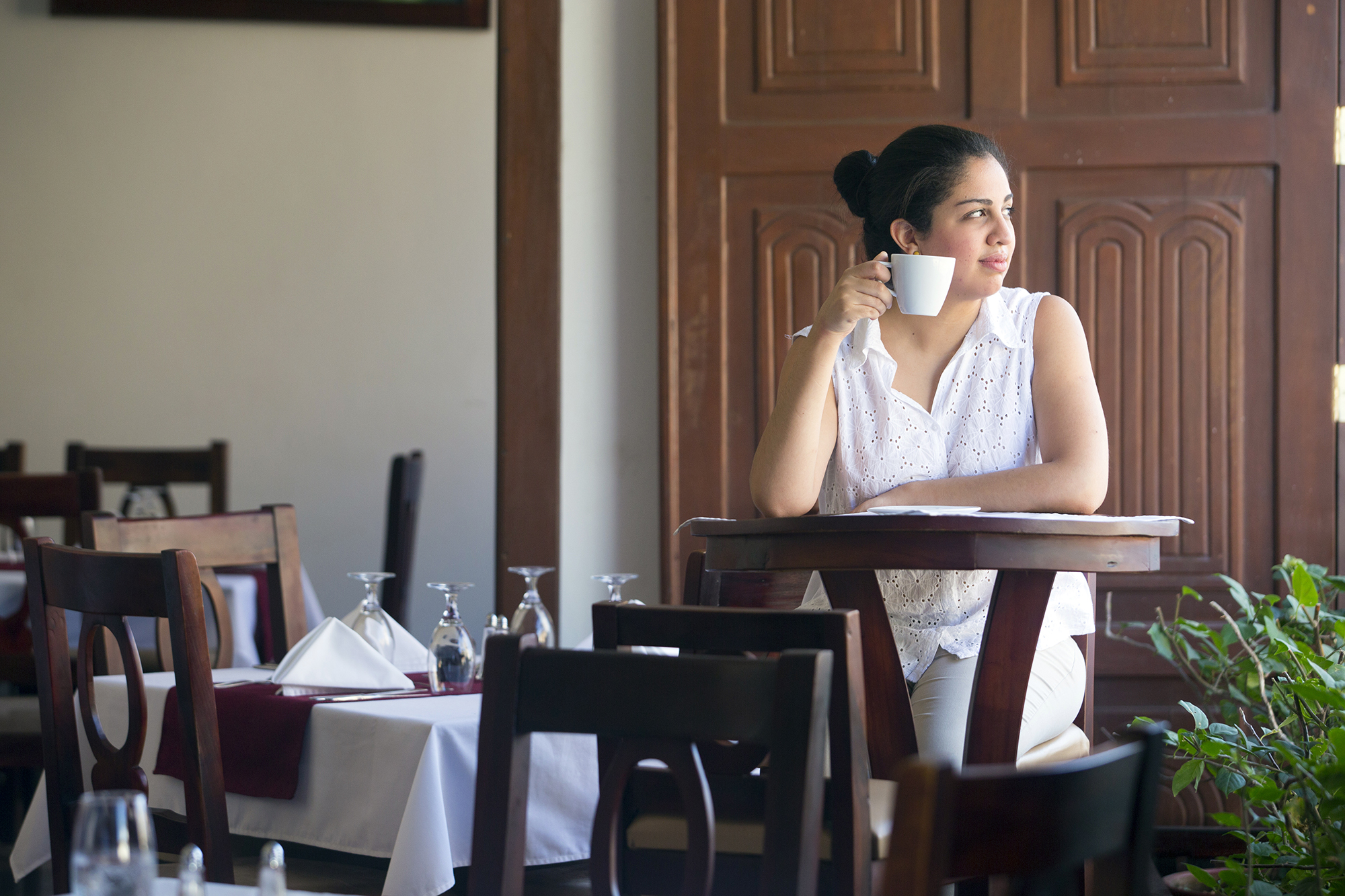 2110 Woman Drinking Coffee In Restaurant Technoserve Hotel Real Copyright Stuart Freedman