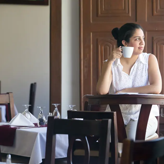 2110 Woman Drinking Coffee In Restaurant Technoserve Hotel Real Copyright Stuart Freedman