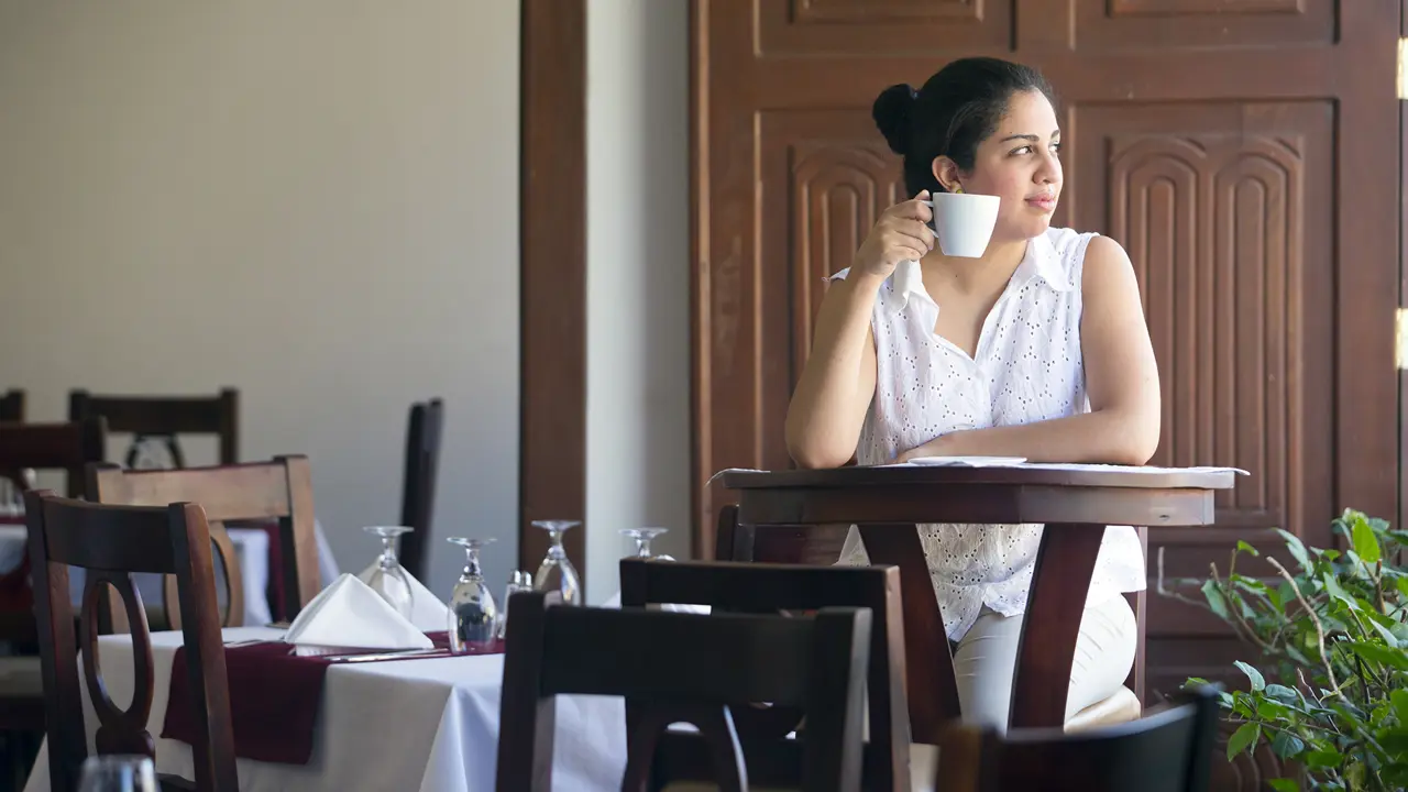 2110 Woman Drinking Coffee In Restaurant Technoserve Hotel Real Copyright Stuart Freedman