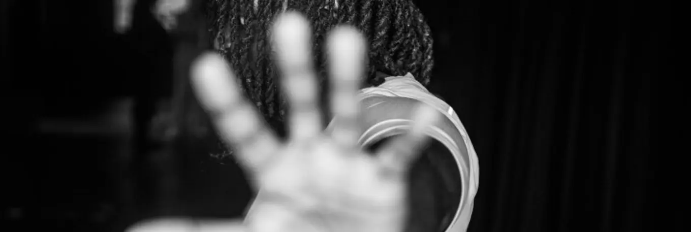 Black and white image of a main holding his hand out