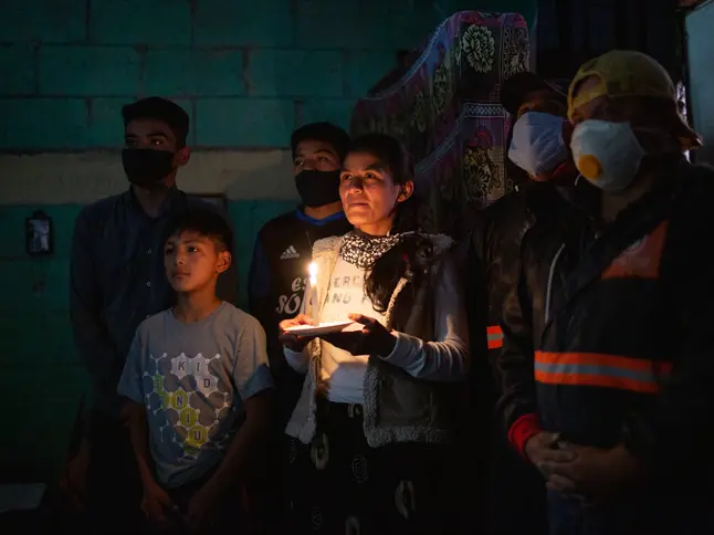 30 Family With Woman Holding Candle Energica Solar Alterna James Rodriguez Copyright Panos