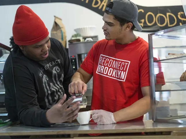 Two men making a latte
