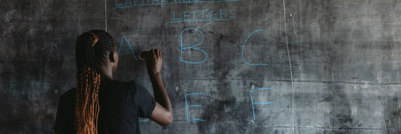 Girl writing on a blackboard
