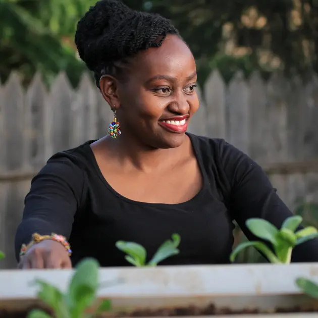 Smiling woman near plants