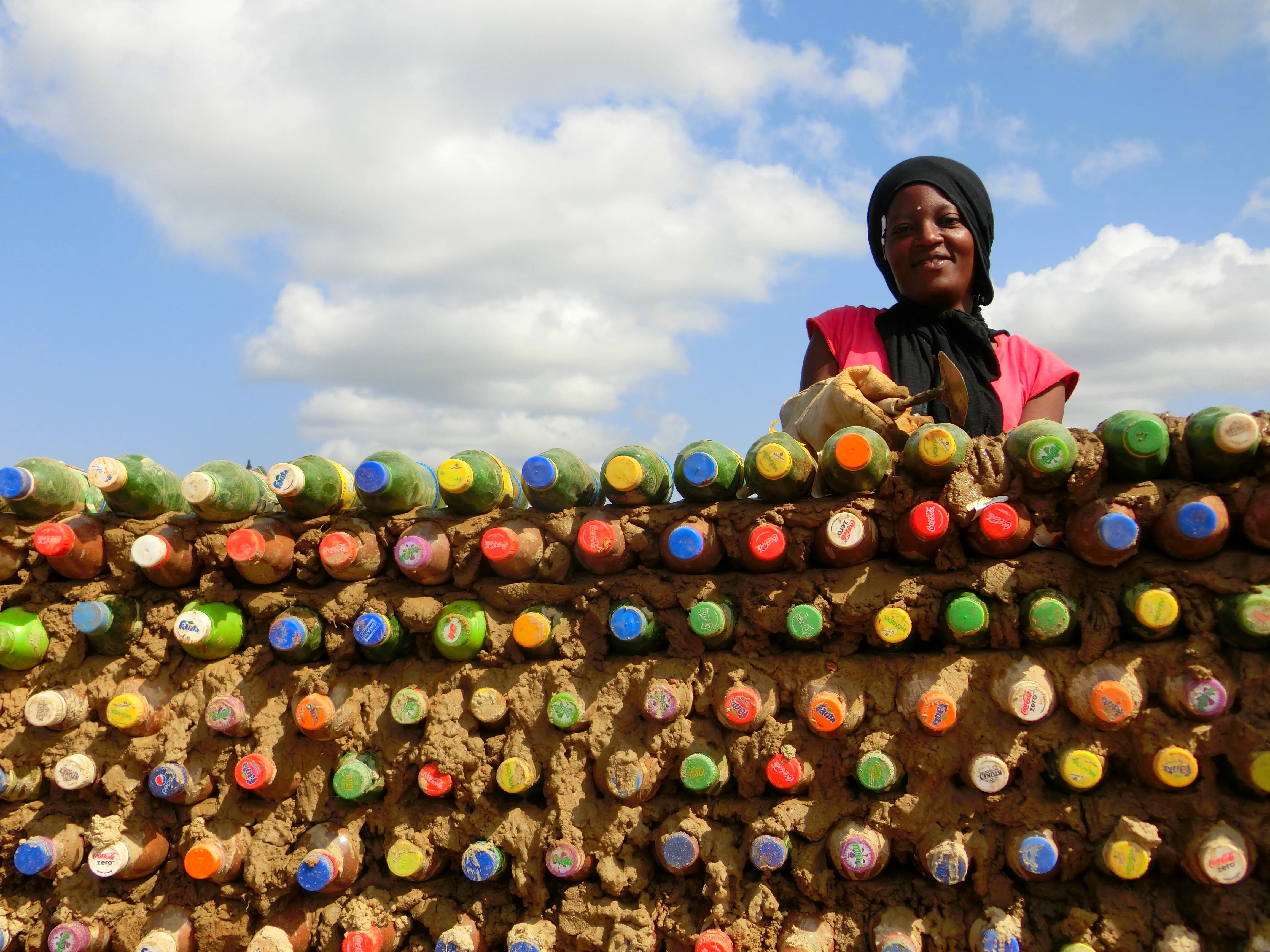 Woman with plastic bottles Sina Construction 2023